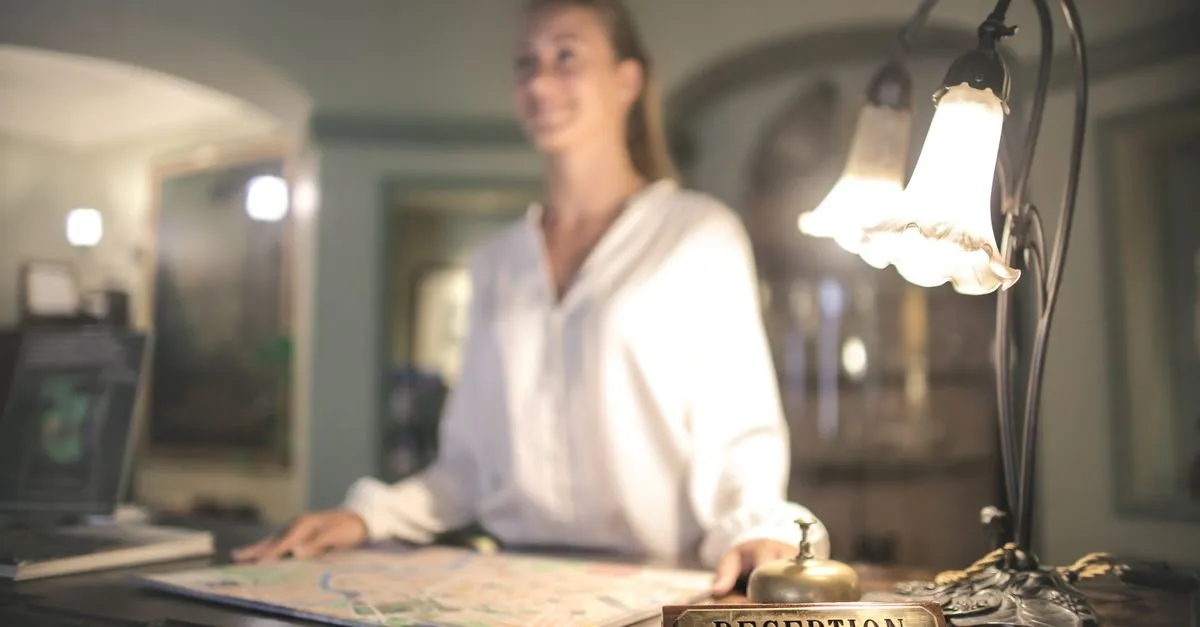 Hotel receptionist assisting a guest